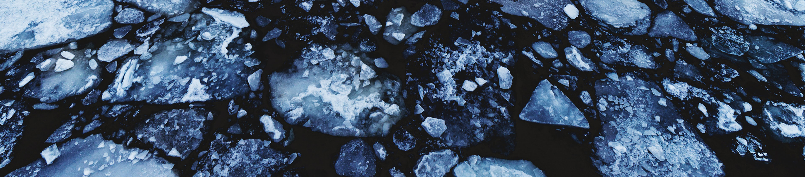 lake in winter with floating ice chunks