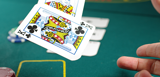 blackjack player tosses cards on the table